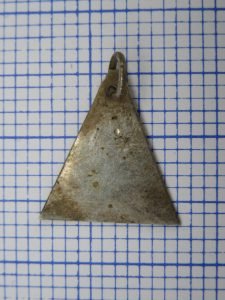 A small triangle of trade silver, discovered Wednesday afternoon, July 12. It appears to have been part of an earring or pendant. Trade silver is an excellent marker for the British era of the fur trade. This came from the interior of the house.