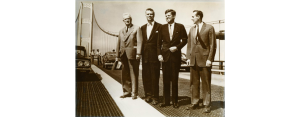 A black and white photo featuring four men, including president John F. Kennedy. 