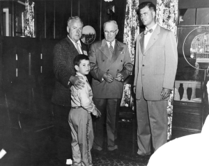 Three adults and a child in a black and white photograph. 