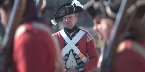 An interpreter at Colonial Michilimackinac at present dressed as a grenadier.